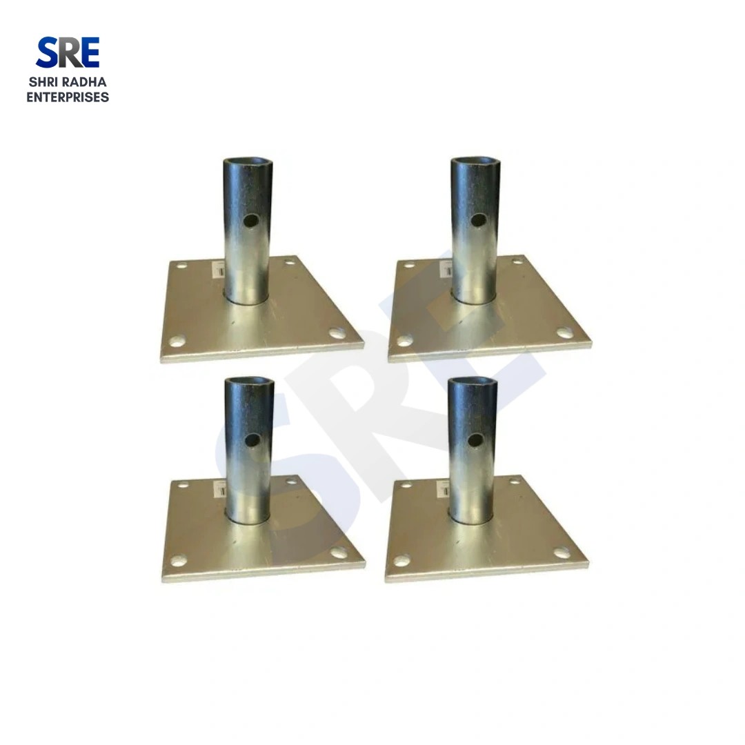 Four heavy-duty square steel Base Plates with vertical welded pipes and corner mounting holes for scaffold structural support.