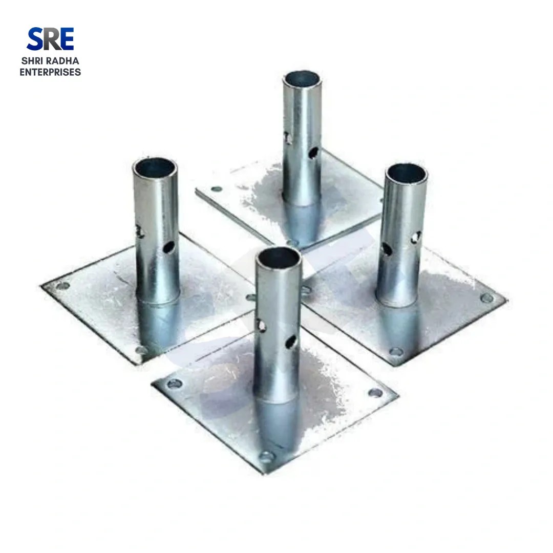 A set of four galvanized square scaffolding base plates with welded vertical spigot pipes and corner holes on a plain white background by Shri Radha Enterprises.